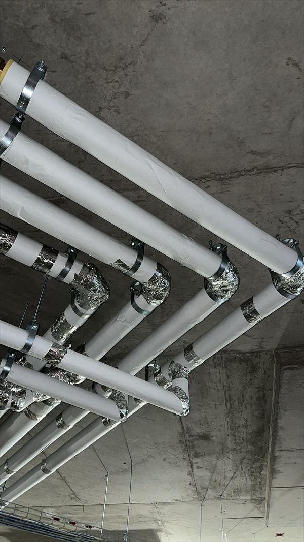 Insulated process piping with foil-jacketed fittings